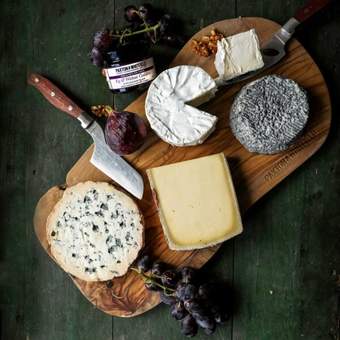 A cheese board showing a selection of seasonal cheeses