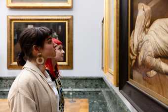 two people look at a work of art in Tate Britain