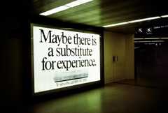 a large digital screen in a gallery space with the words 'maybe there is a substitute for experience'