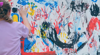 a girl painting with her hands